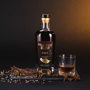 William Hinton 6 years Madeira Rum Bottle in a set with a glass filled with Madeira Rum