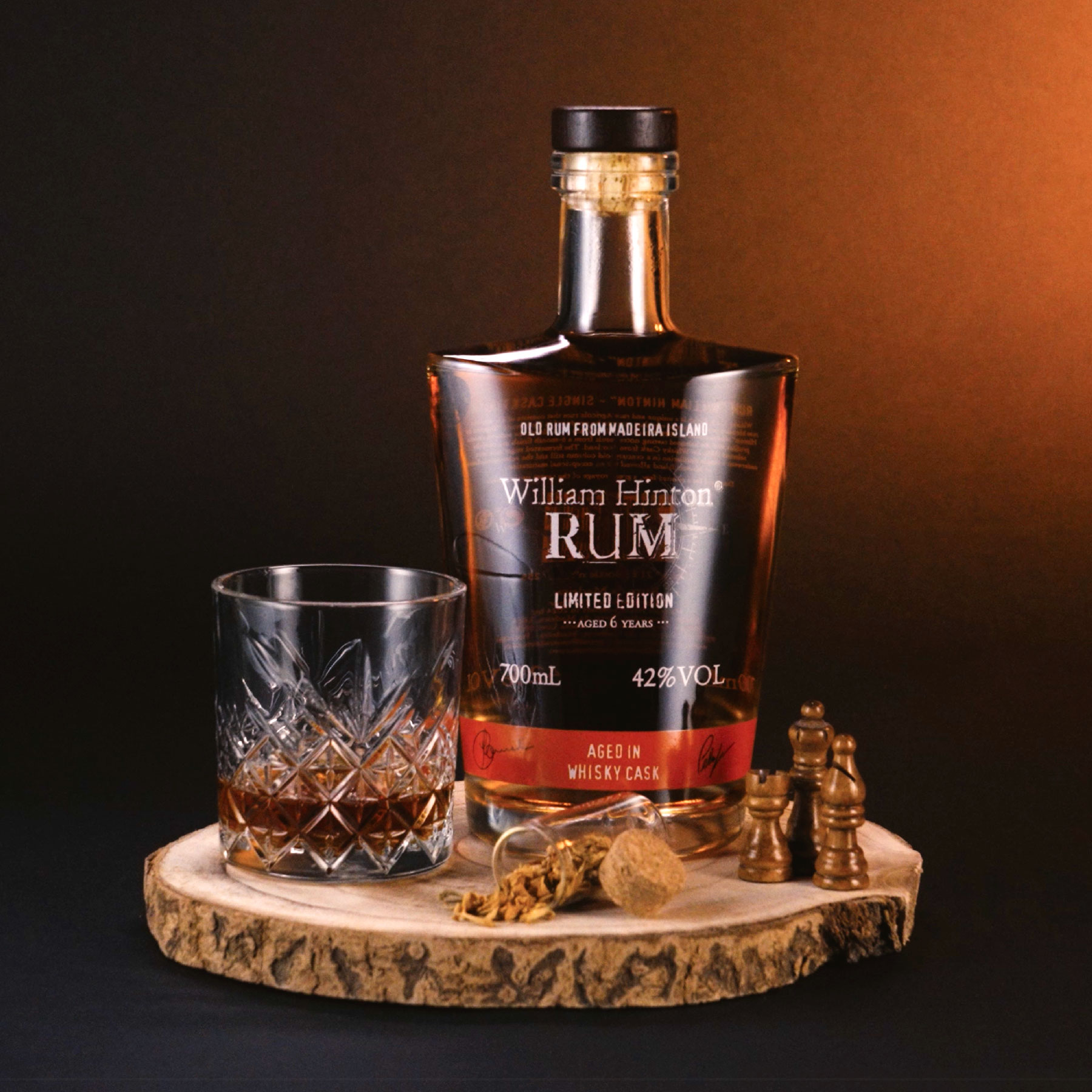 William Hinton Single Whisky Cask Finish Madeira Rum Bottle in a set with a glass filled with Madeira Rum